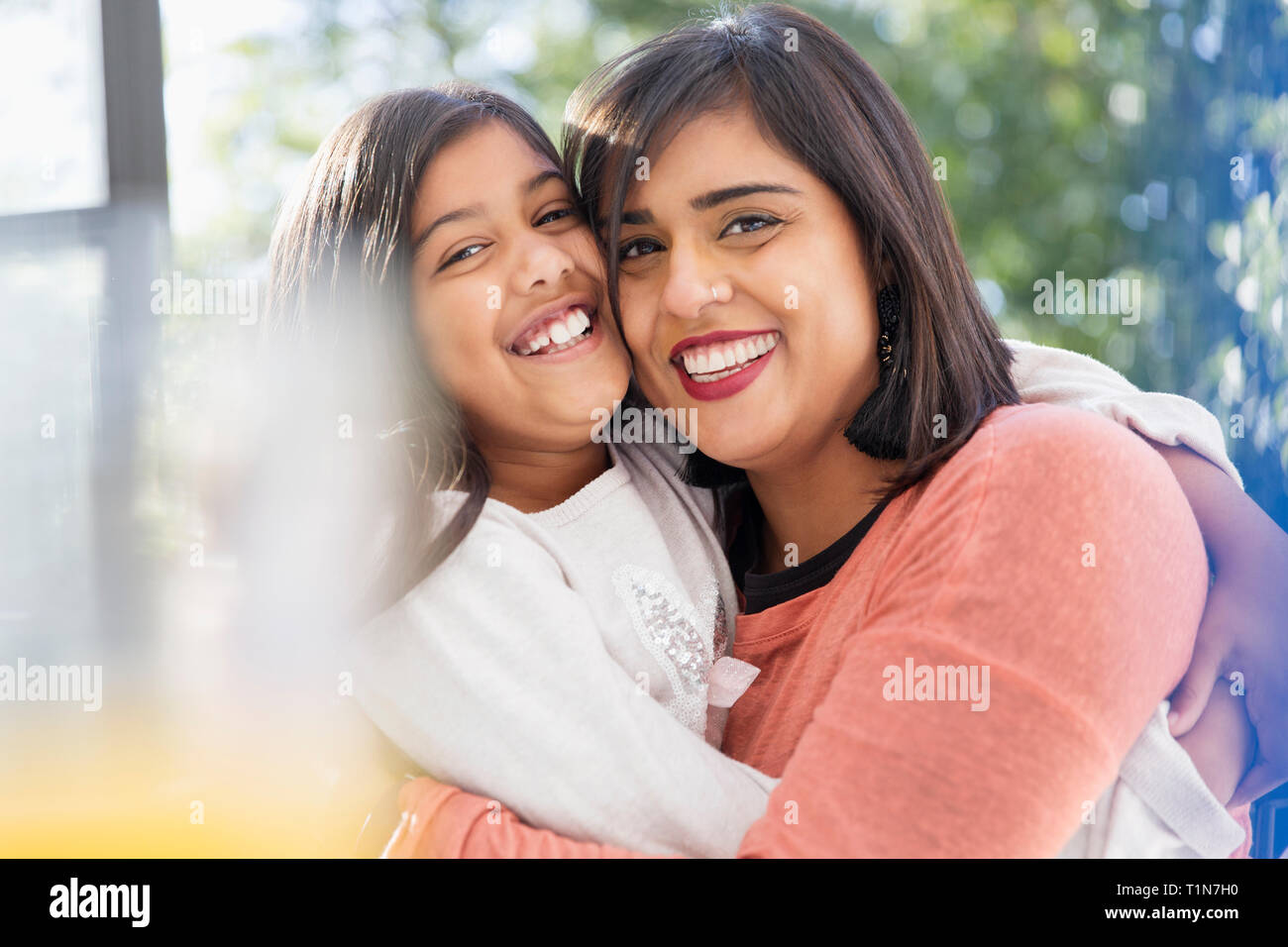 Portrait happy, confident, affectionate mother and daughter hugging Stock Photo