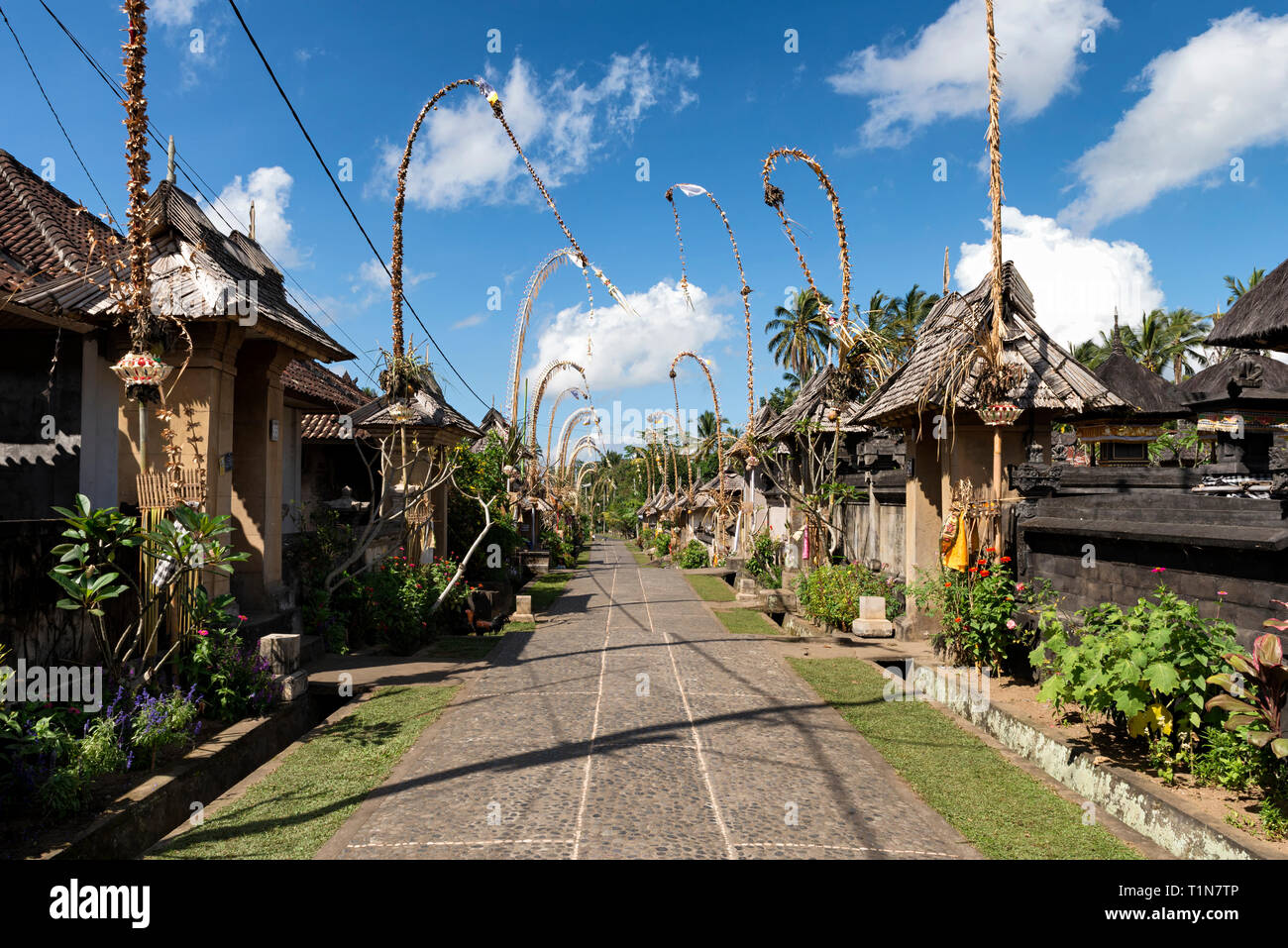 Penglipuran Village decorated with penjor (curved poles with offerings to celebrate Galungan - the victory of good over evil) Stock Photo