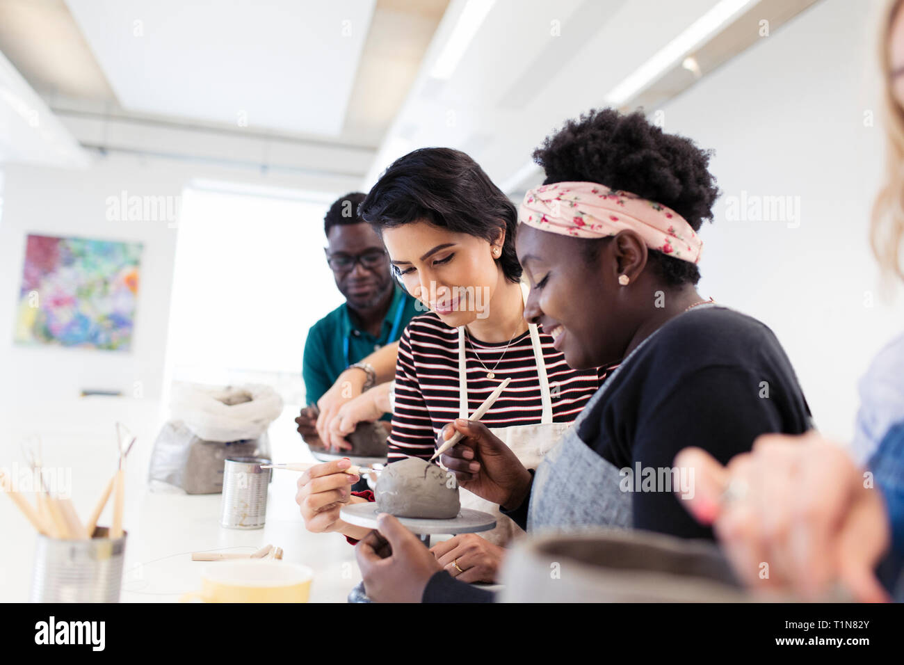 Woman shaping clay in art class Stock Photo