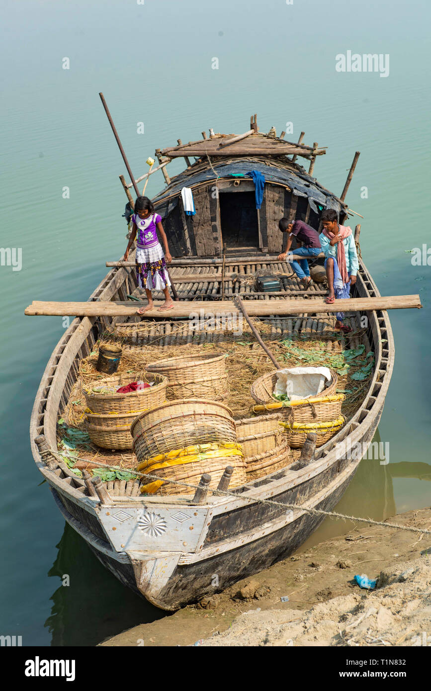 INDIA, BIHAR RAJMAHAL, Small barge being loaded with baskets for transportation to a market along the river Ganges Stock Photo