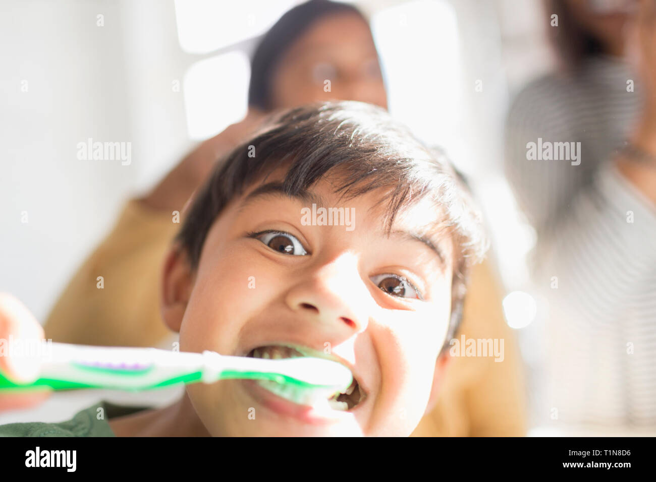 Portrait playful, silly boy brushing teeth Stock Photo