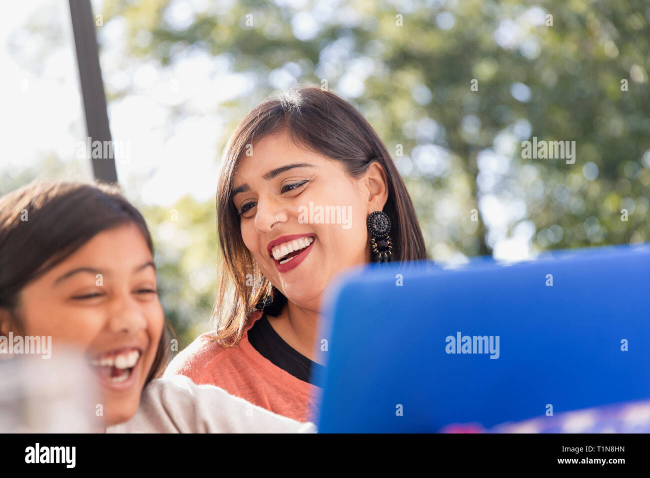 Happy mother and daughter using laptop Stock Photo