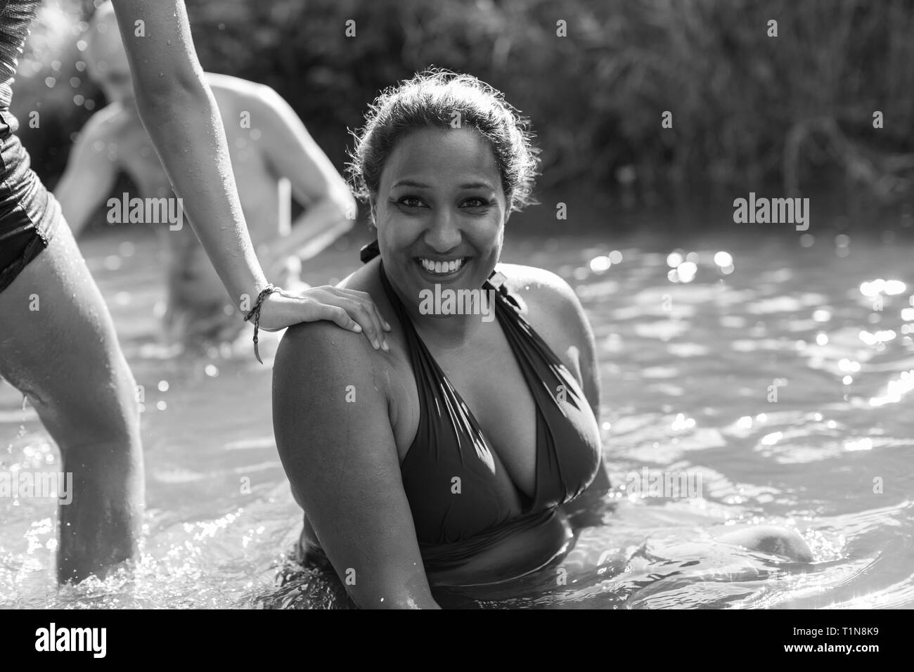 Portrait happy woman swimming in river Stock Photo