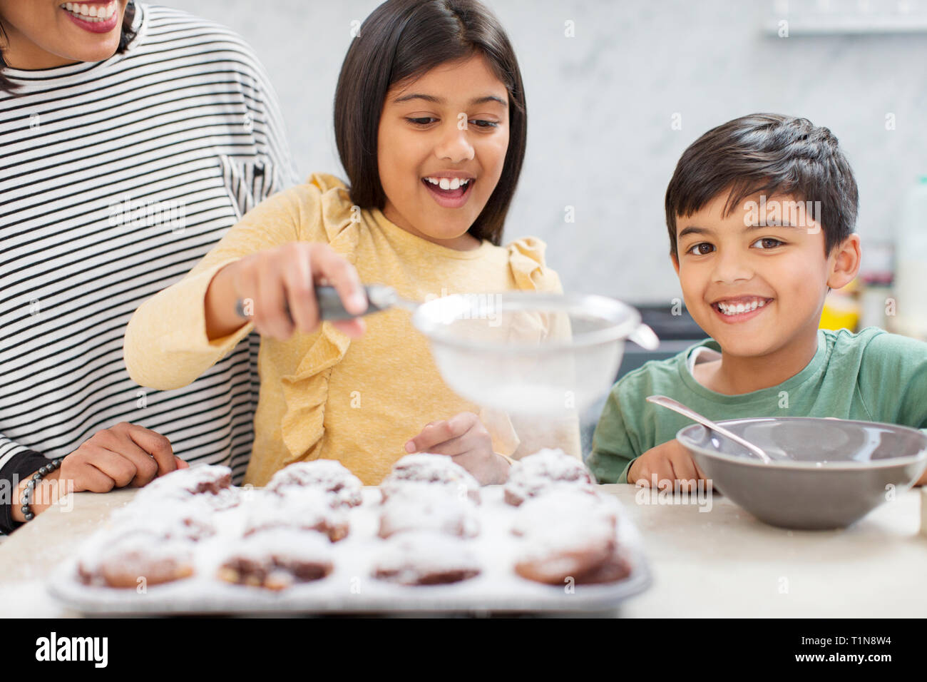 Portrait happy family baking in kitchen Stock Photo
