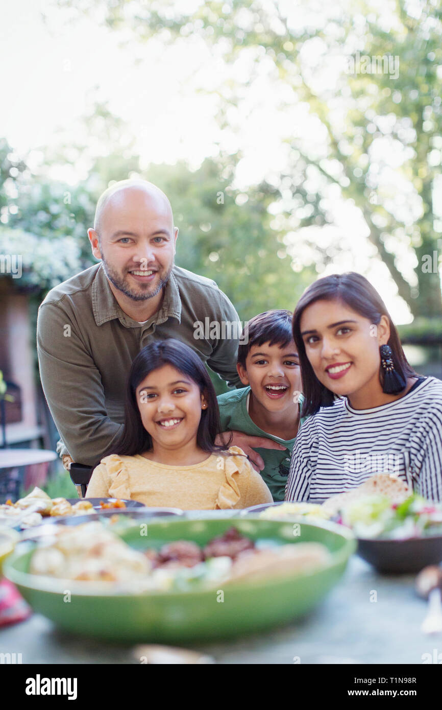 Portrait happy family at dinner table Stock Photo