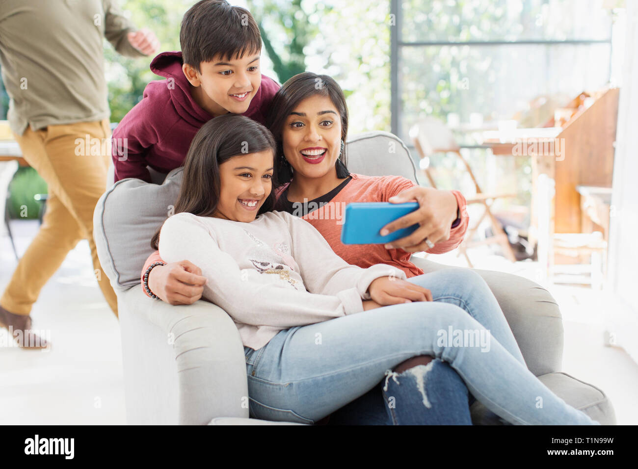 Mother and children taking selfie with camera phone Stock Photo