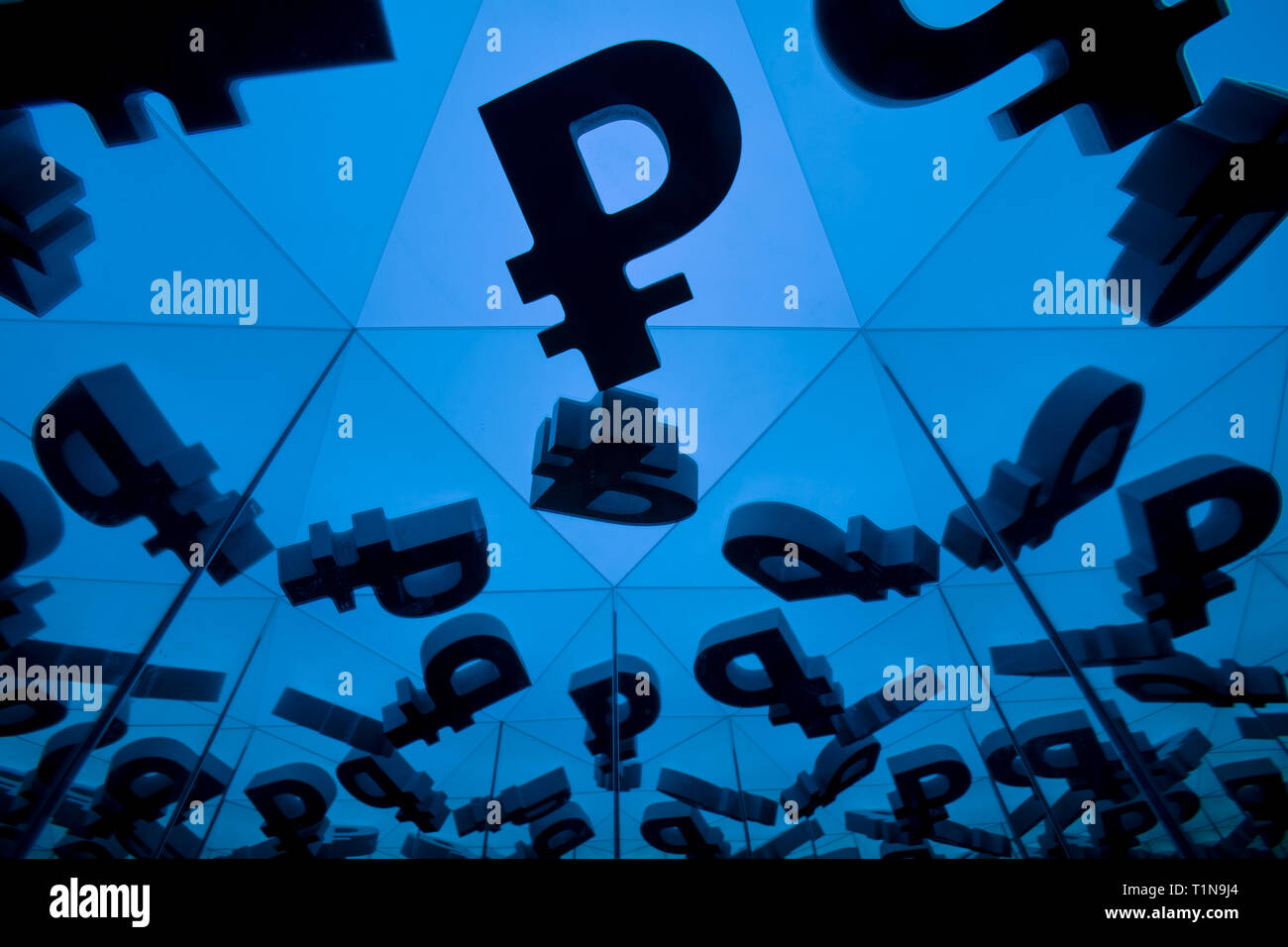 Russian Ruble Currency Symbol With Many Mirroring Images of Itself on Blue Background Stock Photo