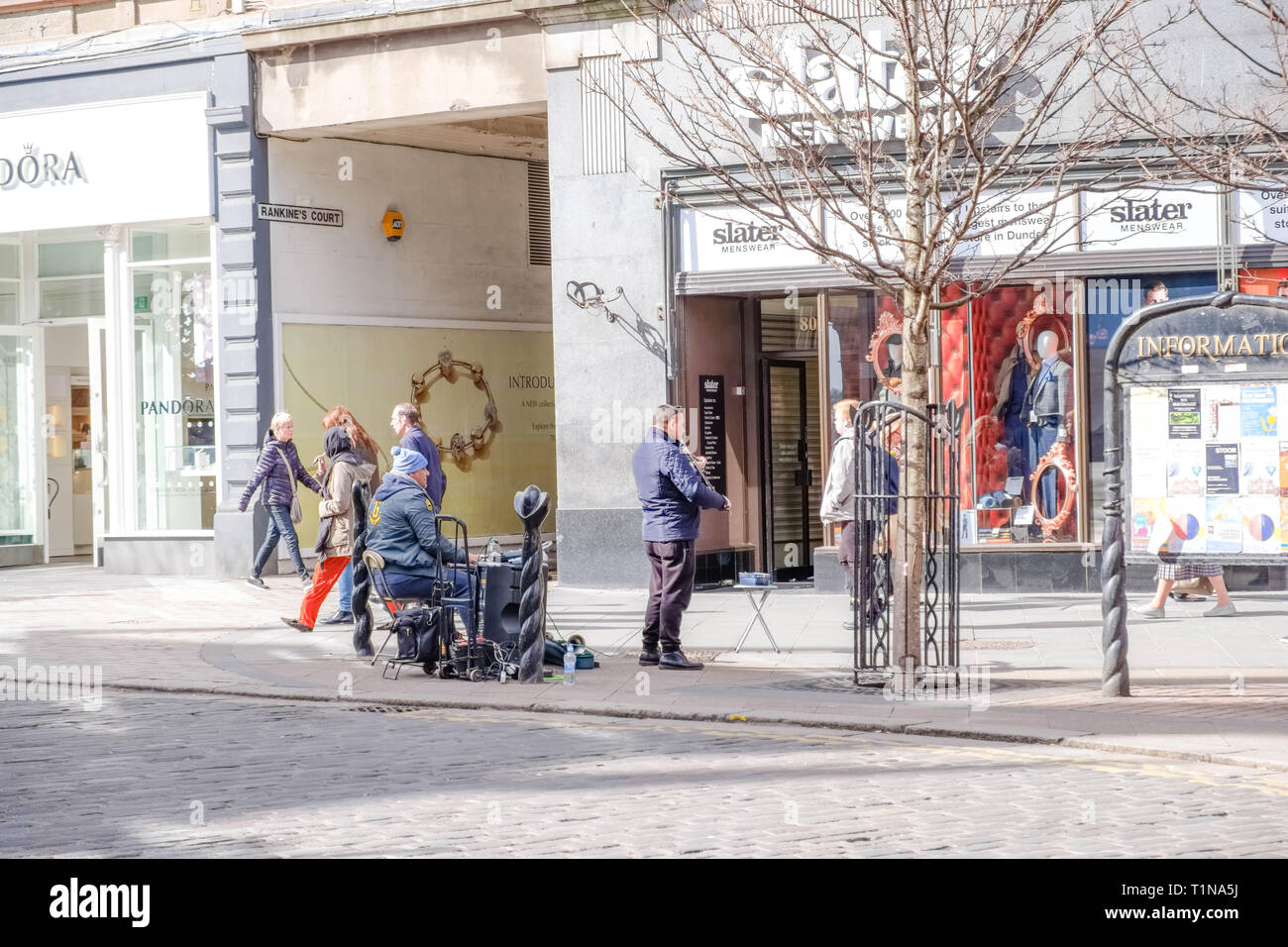Dundee, Scotland, UK - March 23, 2019: People busy shopping and some street entertainers  in  in the City Centre of Dundee in Scotland. Stock Photo