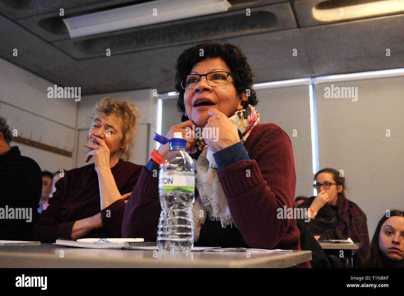 London, England. 16th March, 2019. A member of the audience contributes to the discussions, during the workshop, 'Building alternative mass media' at  Stock Photo
