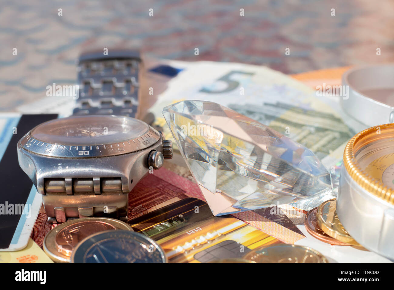 Signs of wealth Euro banknotes, coins, credit card, jewelry, diamonds