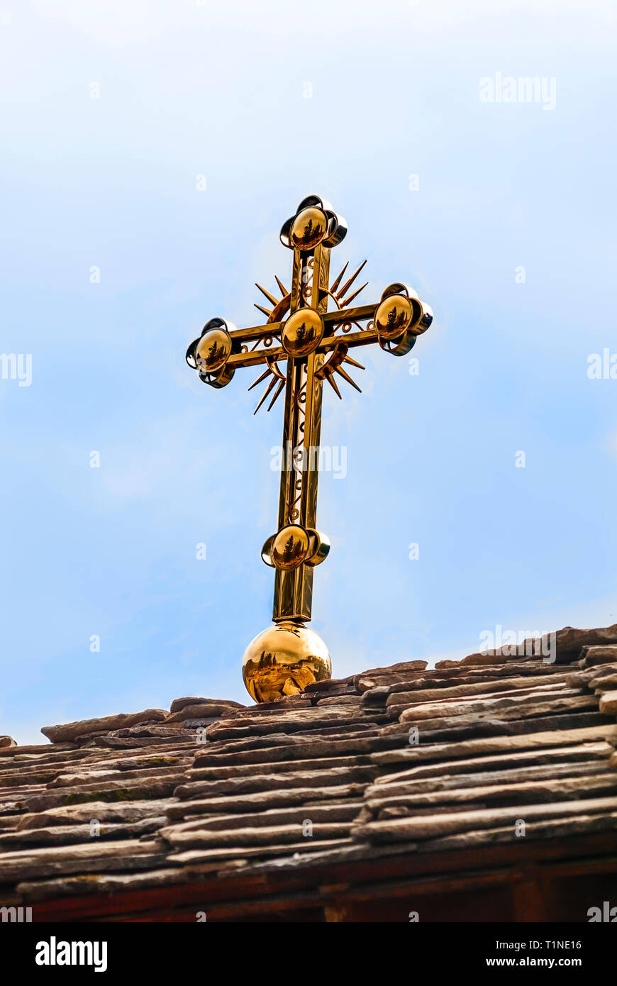a metal cross on the roof of an old church Stock Photo Alamy