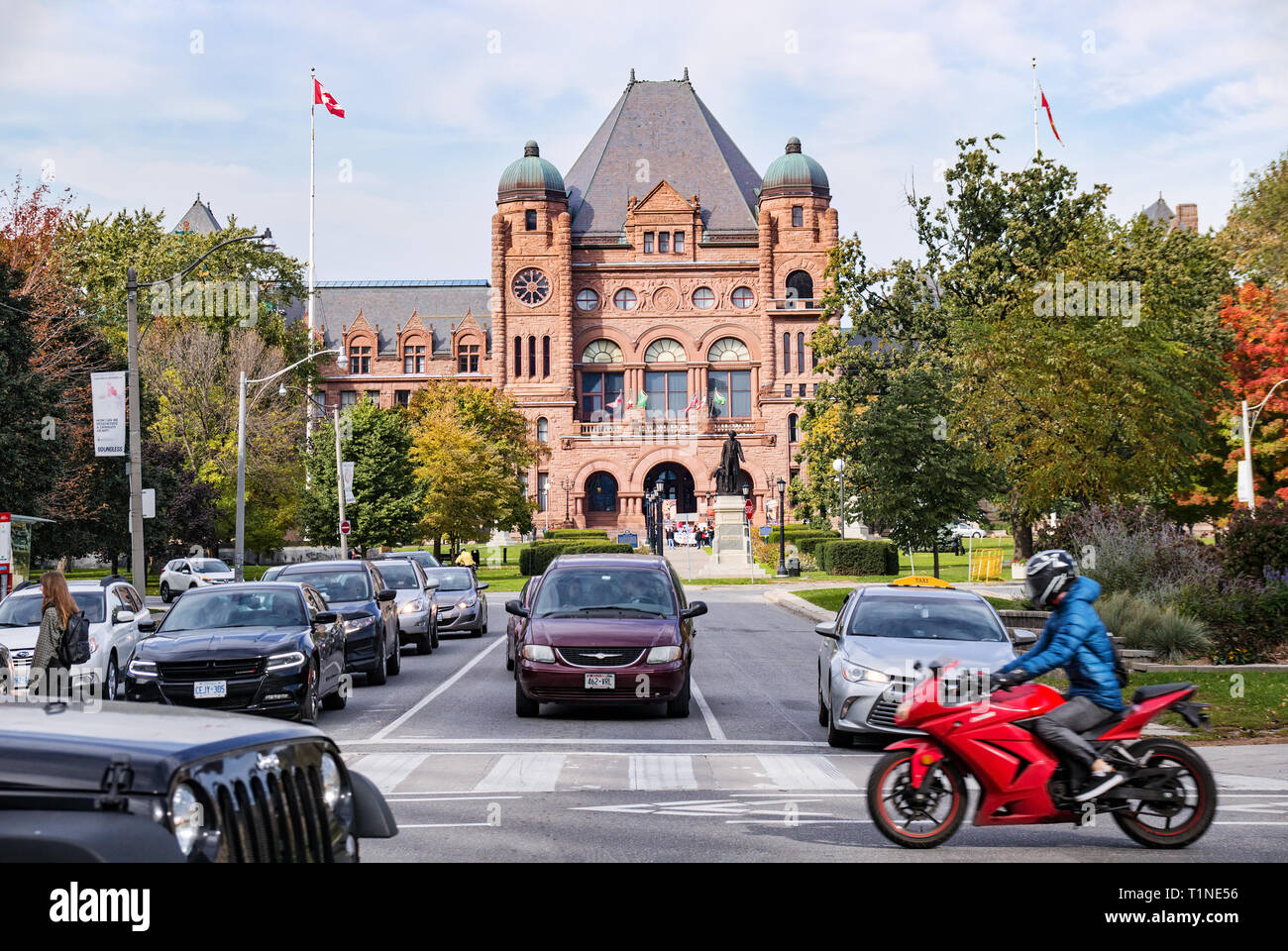 Toronto, Canada - 10 20 2018: Traffic on the College street and Queens Park in front of Legislative Assembly of Ontario building Stock Photo