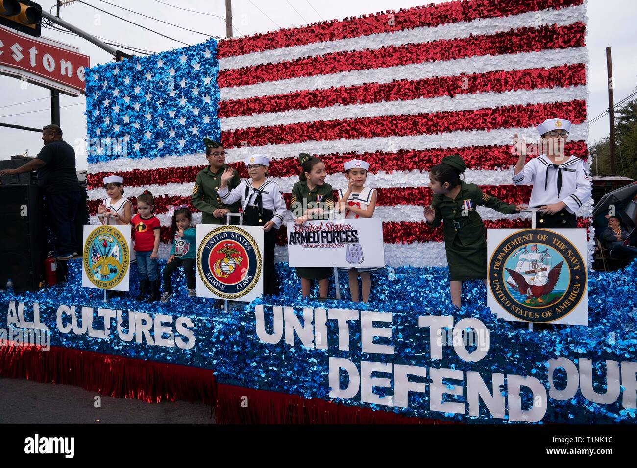 Children dressed in military uniforms ride on float recognizing branches of  the U.S. military during parade in downtown Laredo, Texas Stock Photo -  Alamy