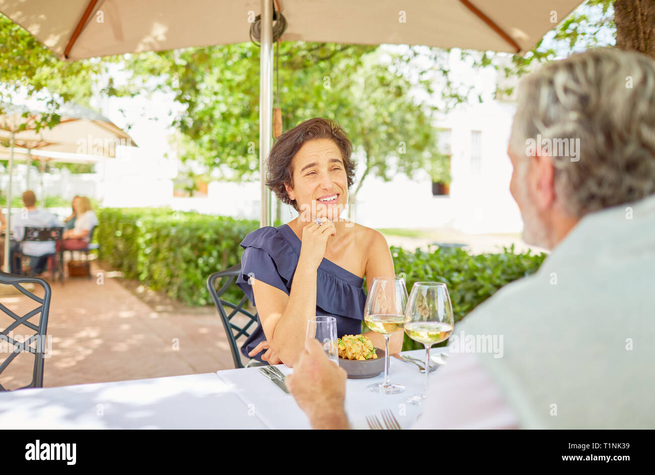 Mature couple dining at resort patio table Stock Photo