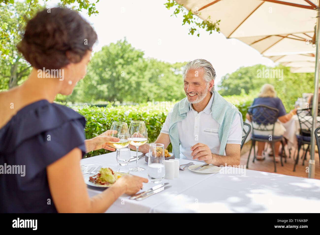 Mature couple dining at patio table Stock Photo