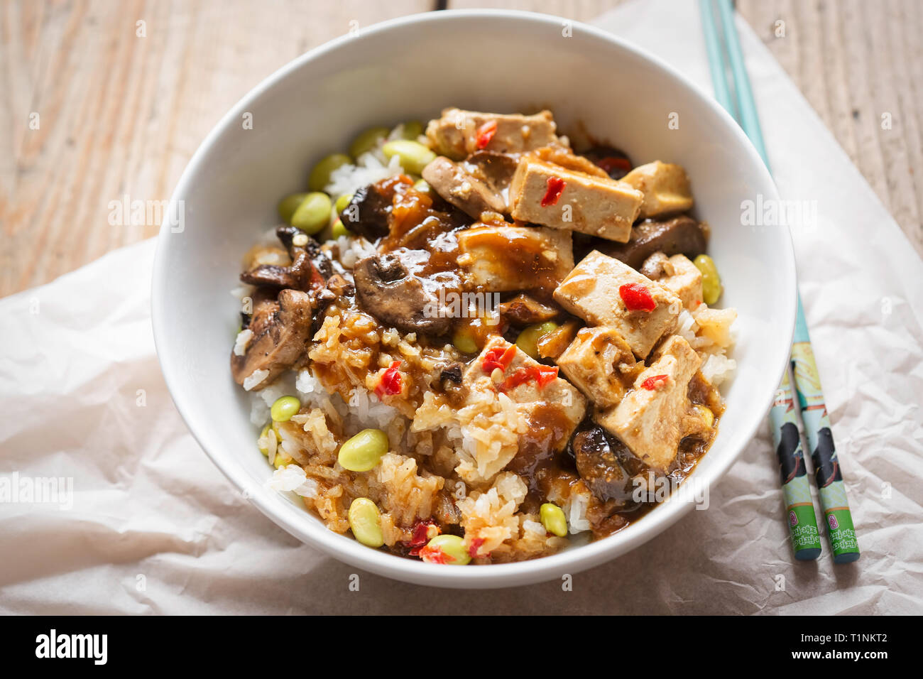 Sticky teriyaki tofu with rice, edamame beans and red chillies Stock