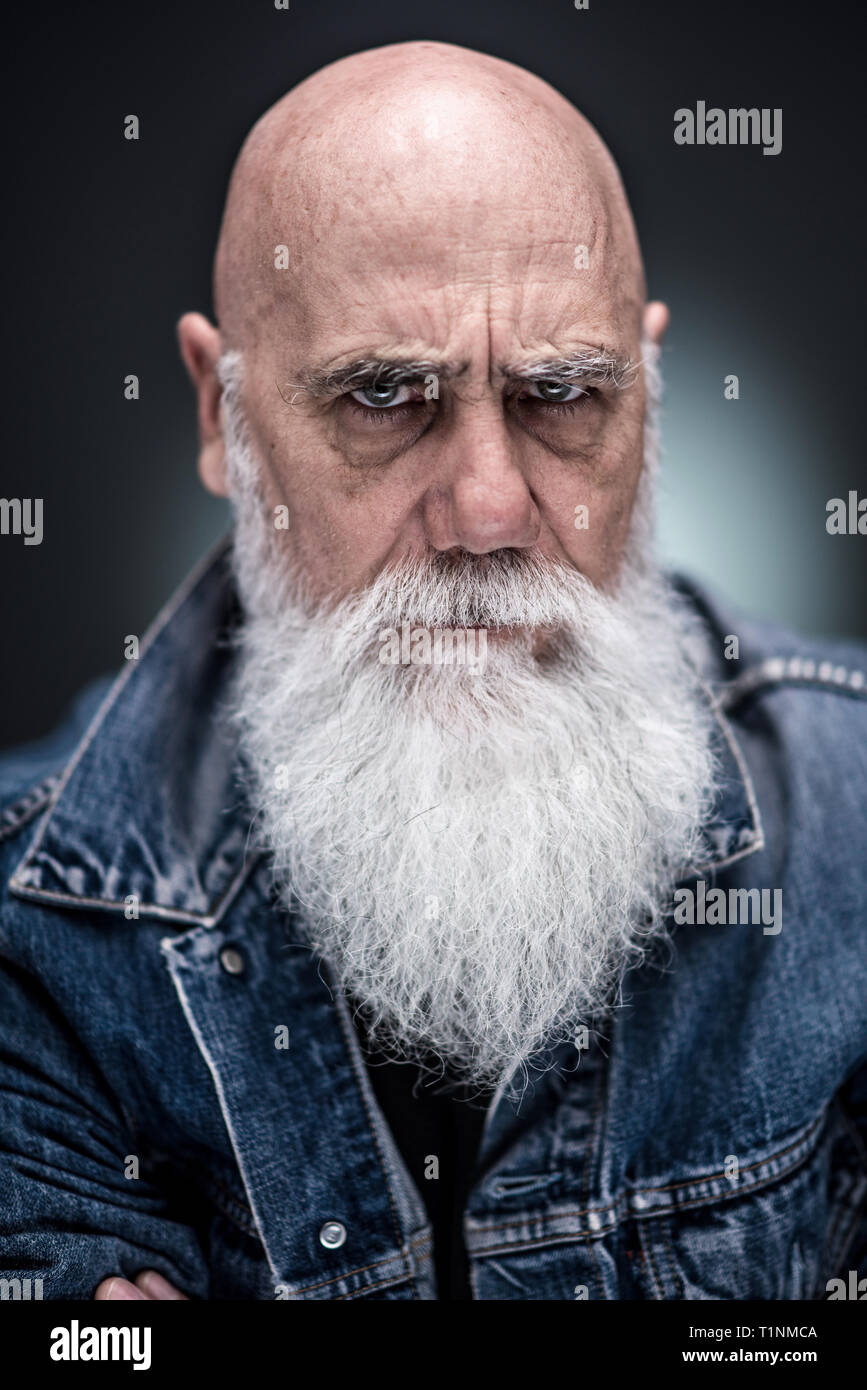 studio portrait of a senior hipster with a long white beard Stock Photo