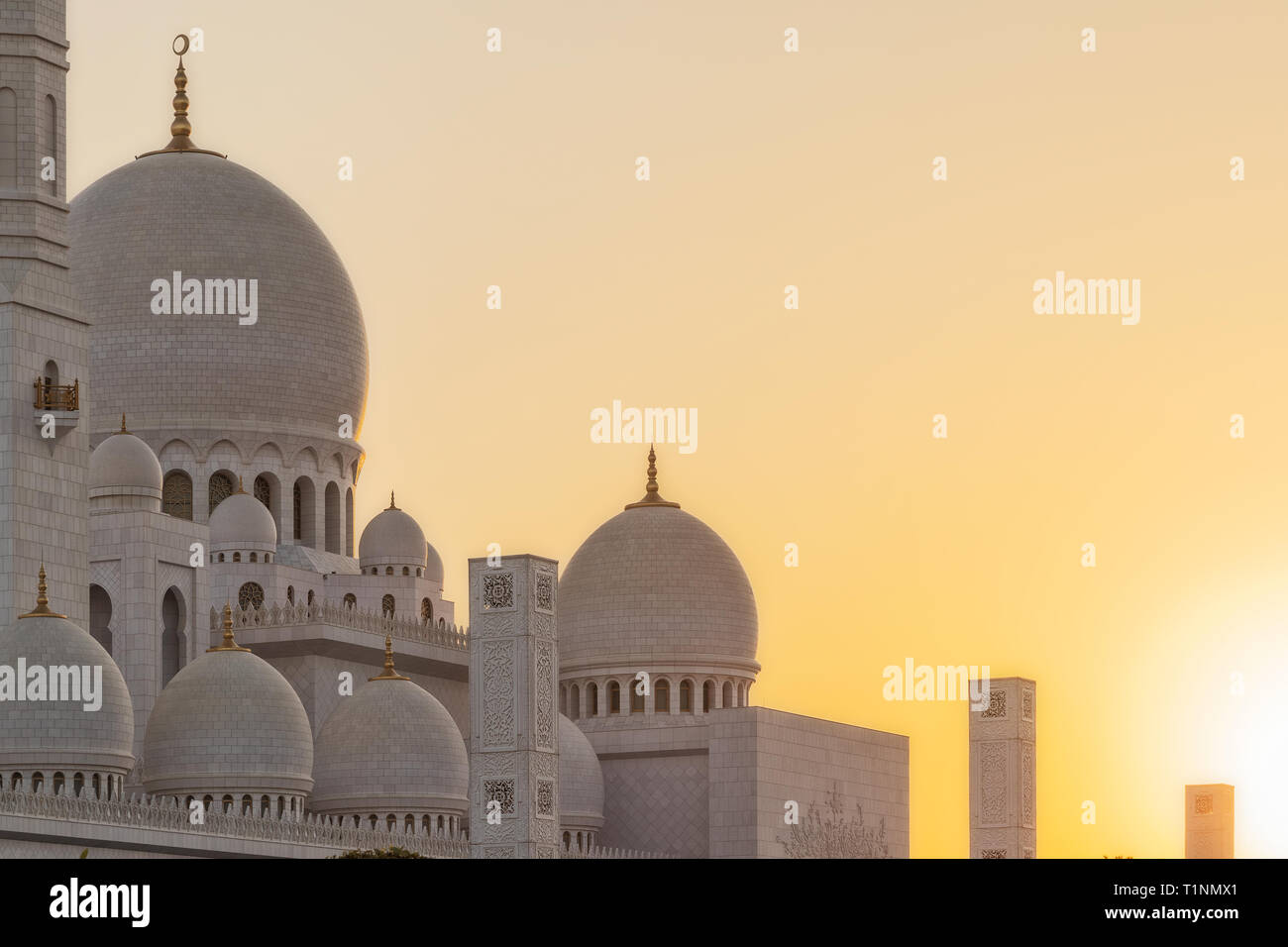 Arabic mosque facade with domes, with sunset light. Great Mosque. UAE. Abu dhabi. Stock Photo