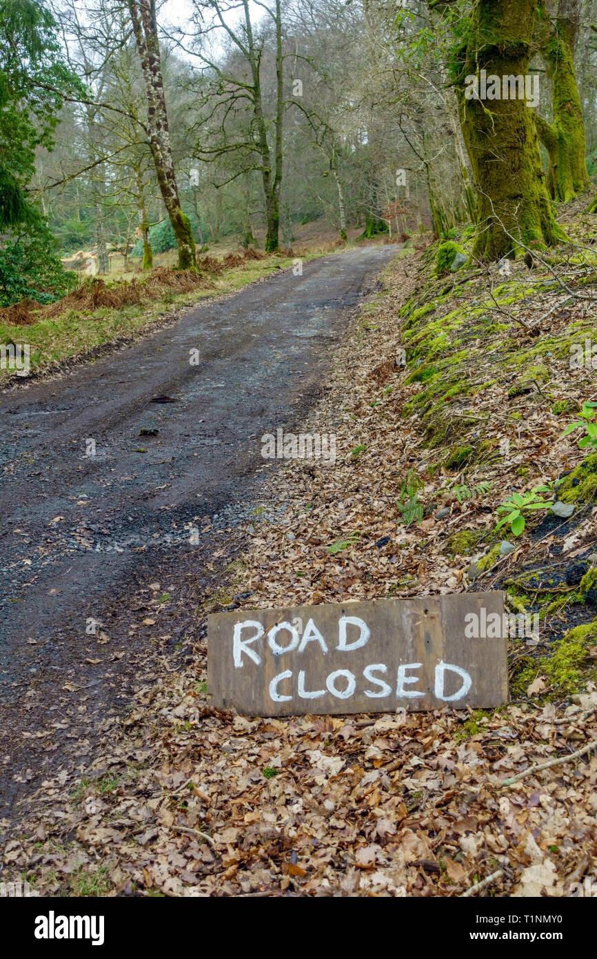 Road closed sign on narrow country road in Scotland Stock Photo