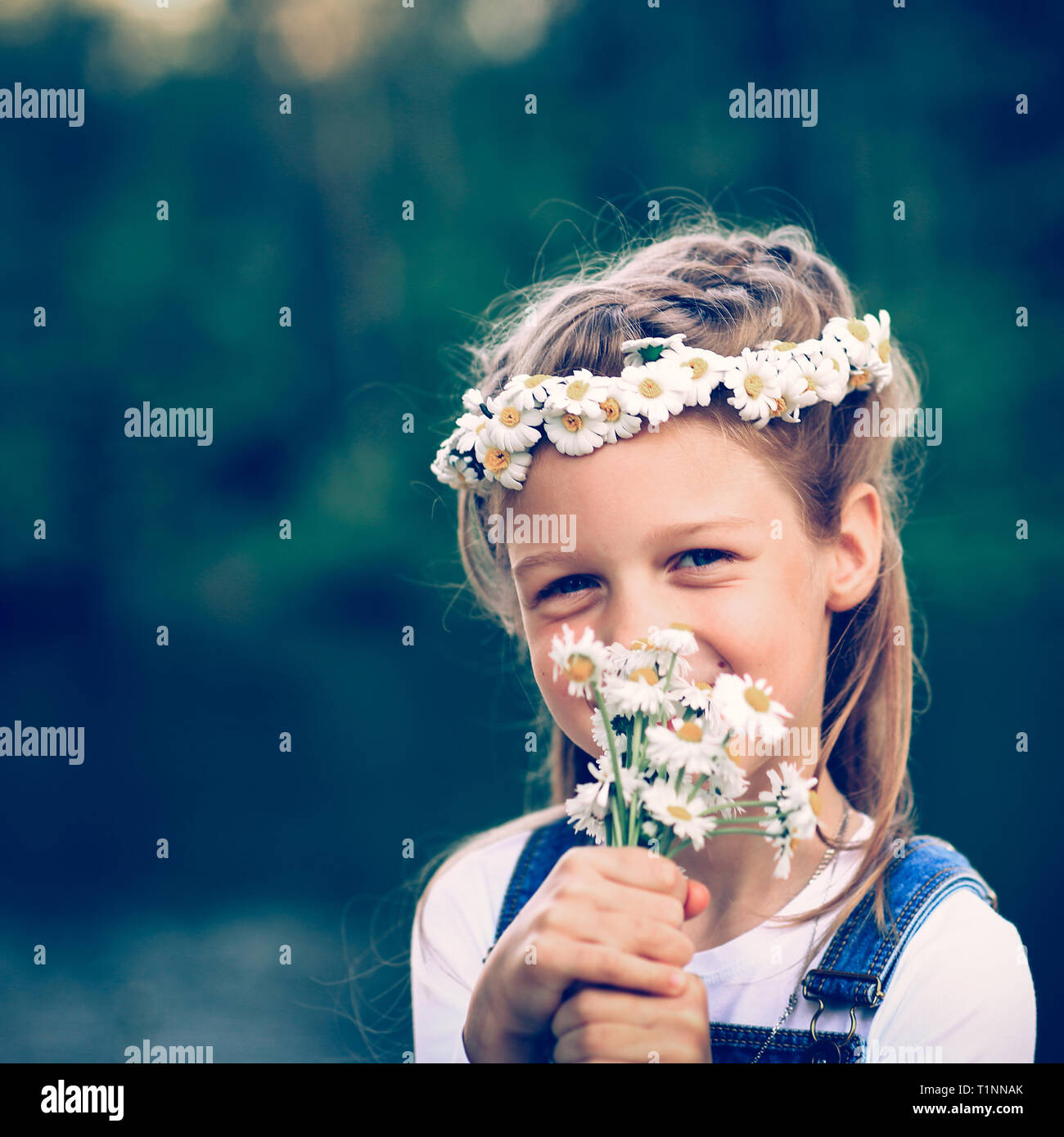 portrait of cute little girl in a wreath and a bouquet of wild f Stock ...