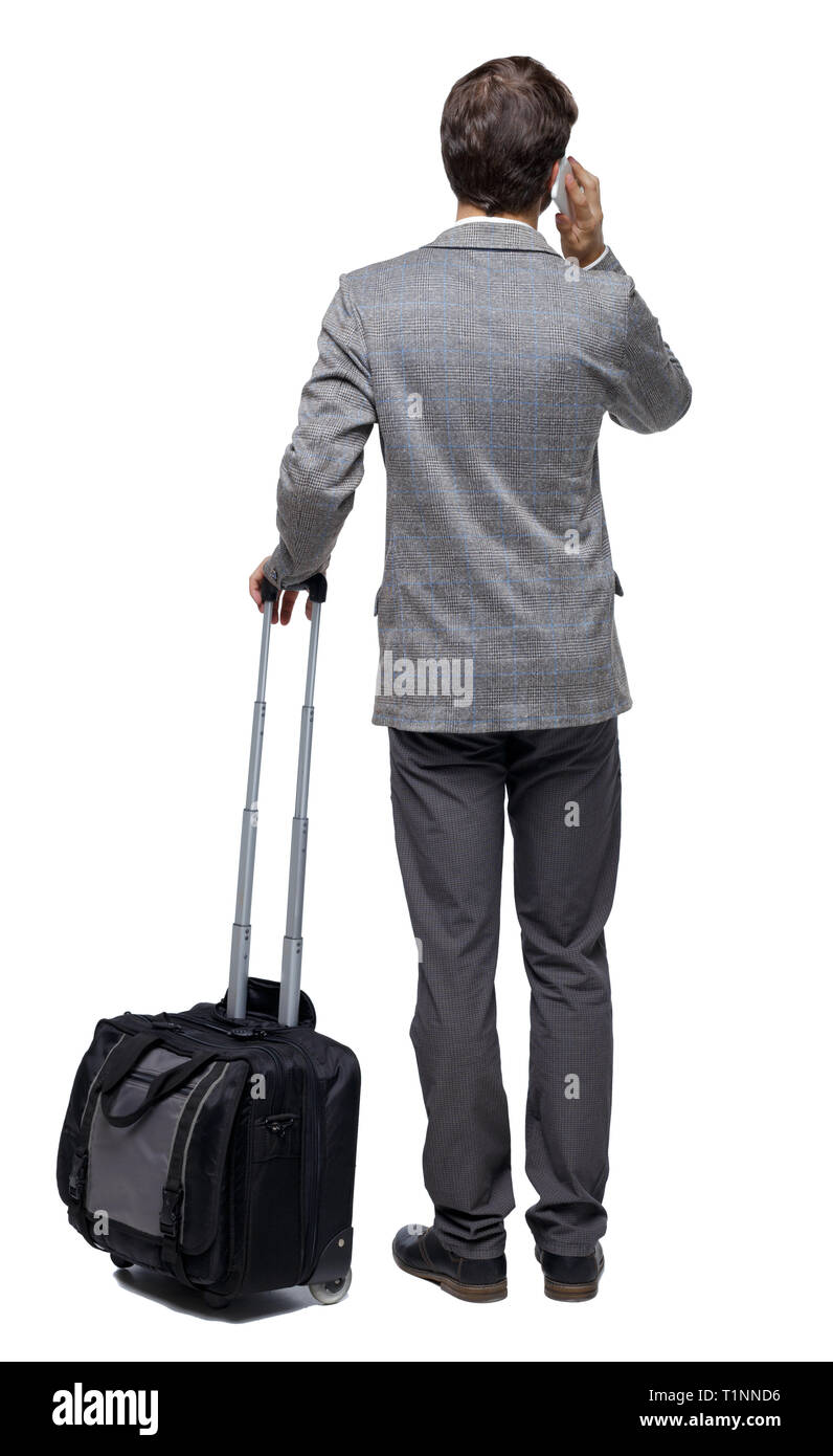 Back view of business man with suitcase talking on the phone. Standing ...