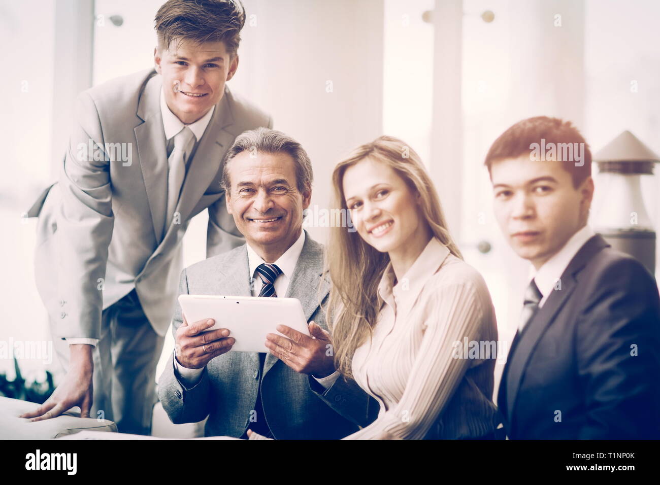 serious business team with tablet computers, documents having discussion in office Stock Photo