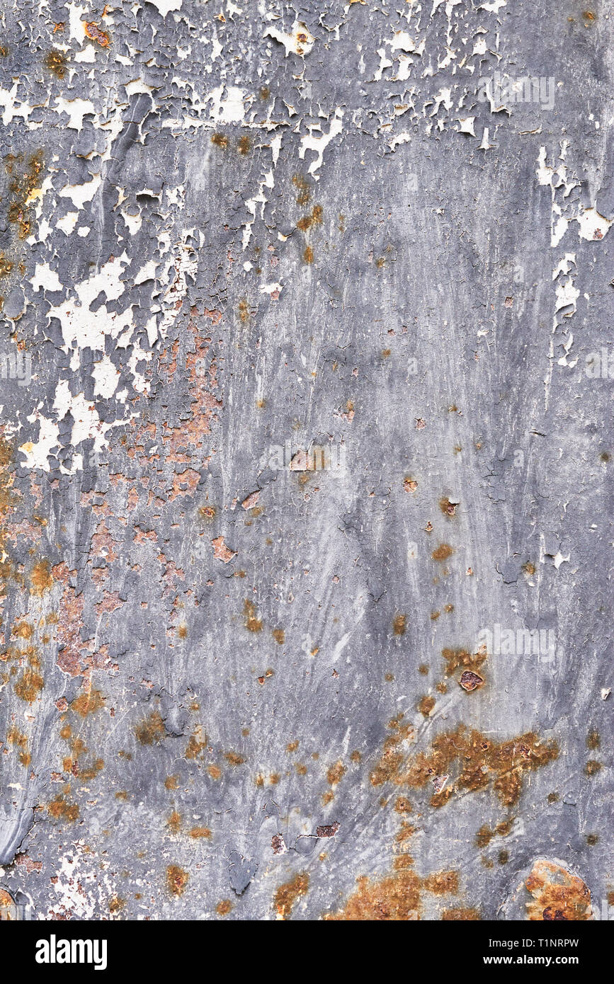 Rusty metal surface with dark blue paint flaking and cracking texture. Rusty metal background. Stock Photo