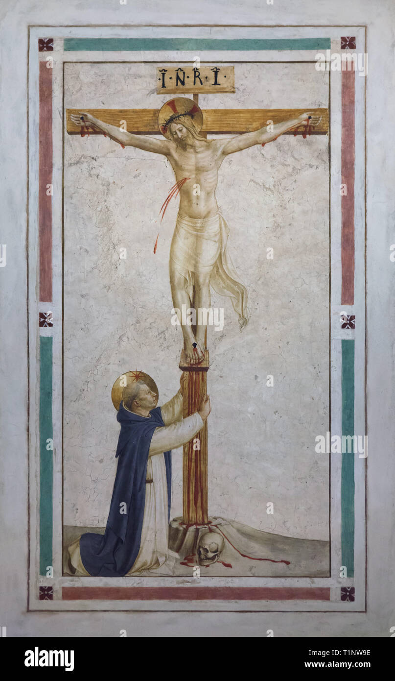 Fresco 'Saint Dominic adoring the Crucifixion' by Italian Early Renaissance painter Fra Angelico (1440-1442) painted on the wall in the monk's cell at the San Marco Convent (Convento di San Marco), now the San Marco Museum (Museo Nazionale di San Marco) in Florence, Tuscany, Italy. Stock Photo
