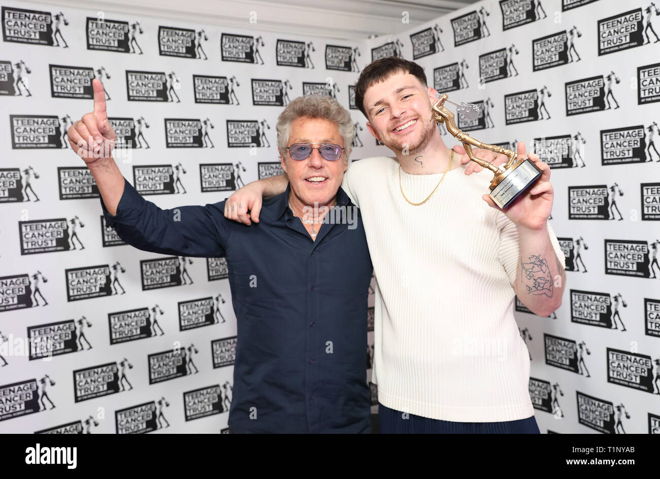 TCT's Honorary Patron Roger Daltrey CBE gives an award to Tom Grennan ahead of his performance at the Teenage Cancer Trust Concert, Royal Albert Hall, London. PRESS ASSOCIATION. Picture date: Wednesday March 27, 2019. See PA story SHOWBIZ TCT. Photo credit should read: Isabel Infantes/PA Wire Stock Photo