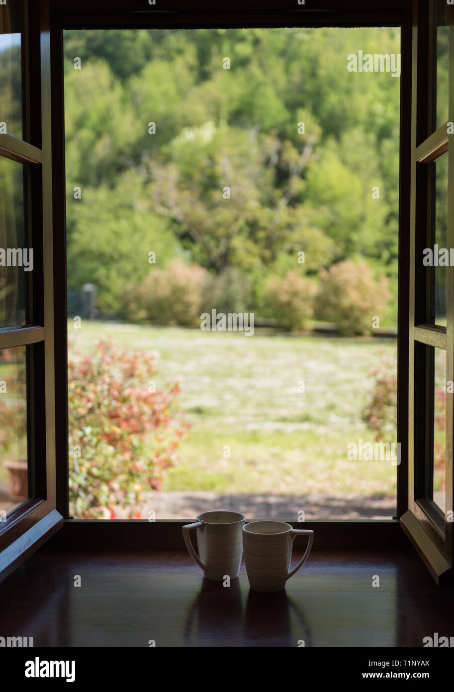 white coffee cups on the windowsill, blur background Stock Photo