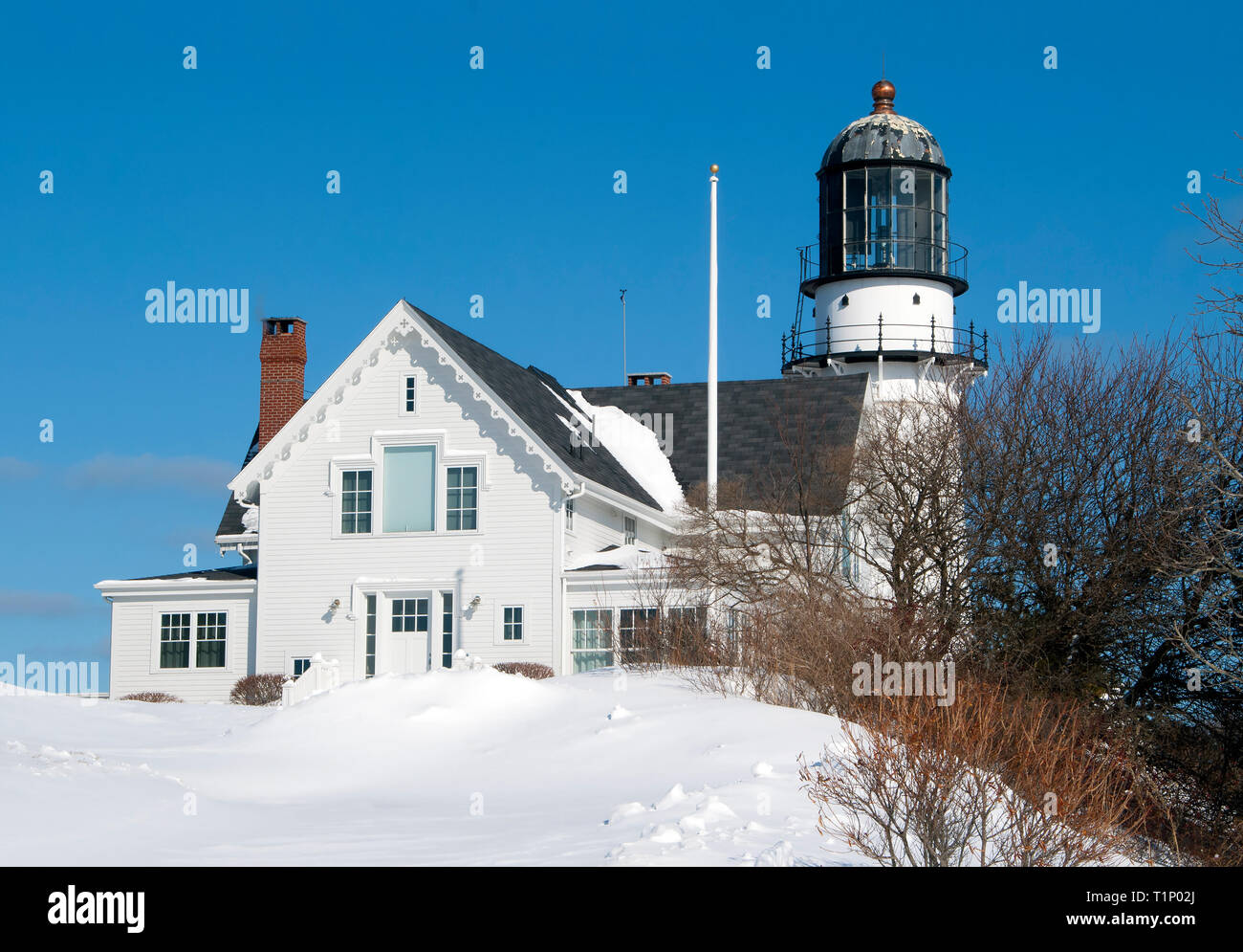 Cape Elizabeth lighthouse in Maine is buried in snow after a winter snowstorm passed the day before. Stock Photo