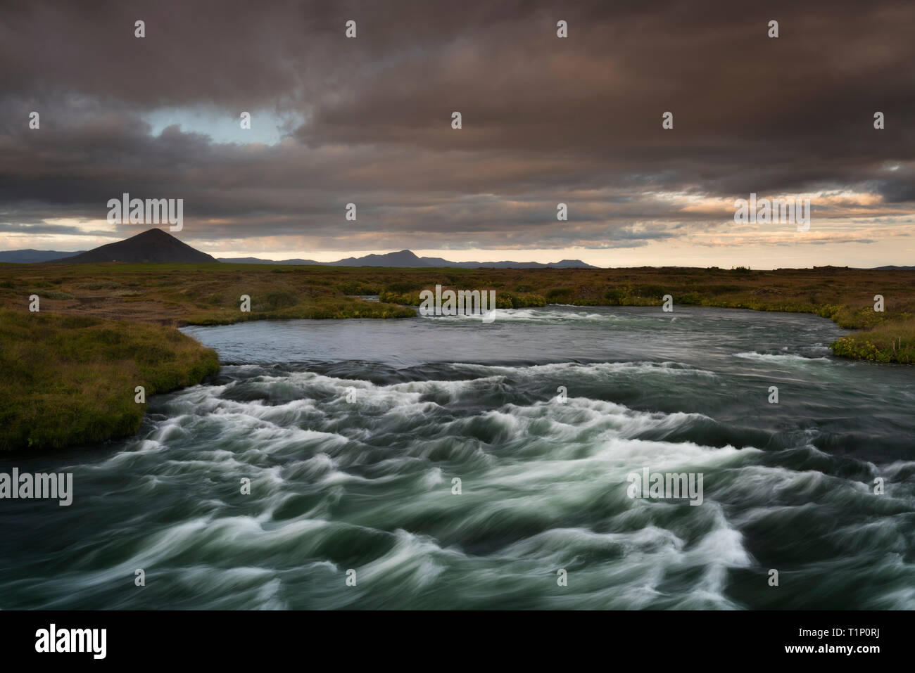 Blue river captured with long exposure among valley in South Iceland ...