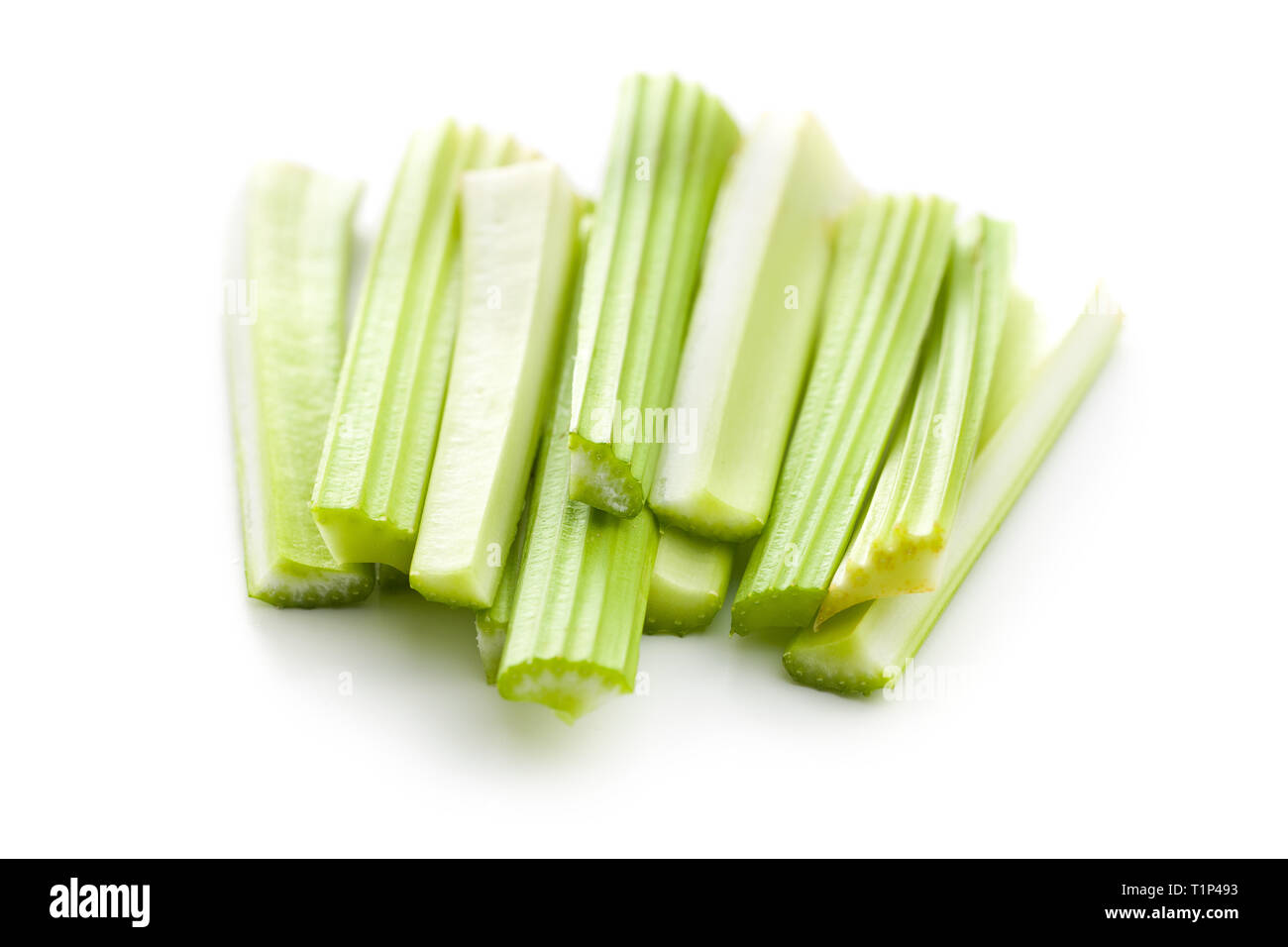 Celery sticks. Cutting celery stalks isolated on white background. Stock Photo