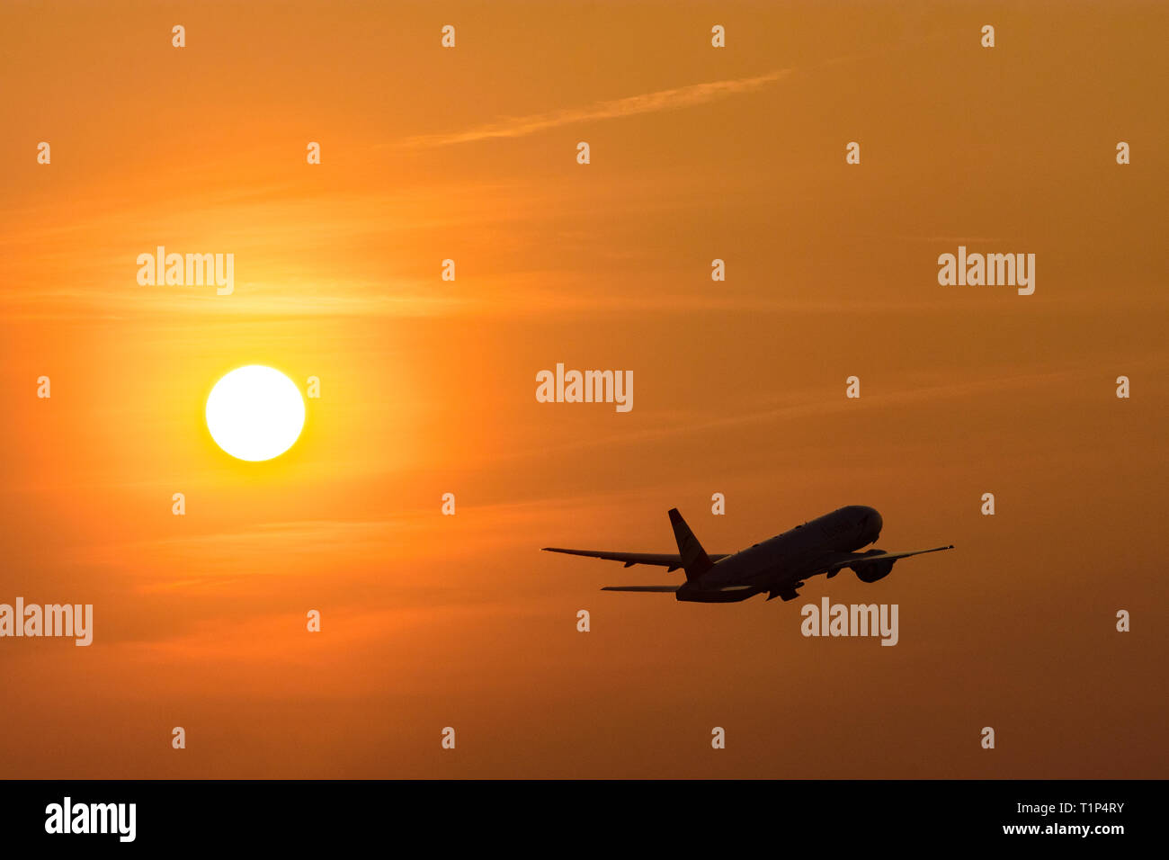 aircraft at takeoff, setting sun Stock Photo