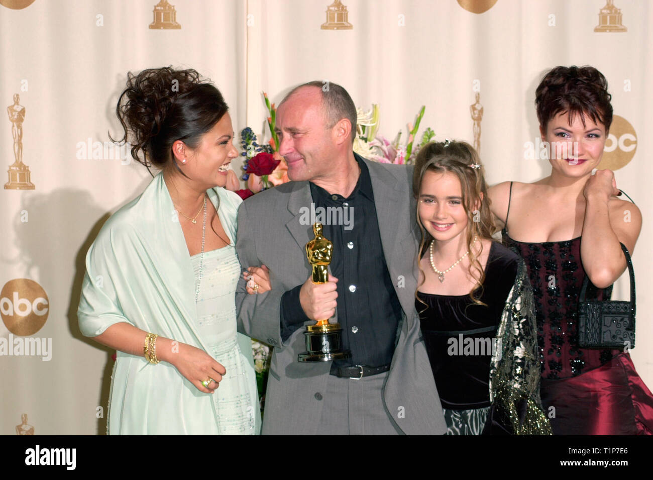 LOS ANGELES, CA. March 26, 2000:  Pop star Phil Collins with wife ORIANNE (left) & daughters JOELY & LILY at the 72nd Academy Awards. © Paul Smith / Featureflash Stock Photo