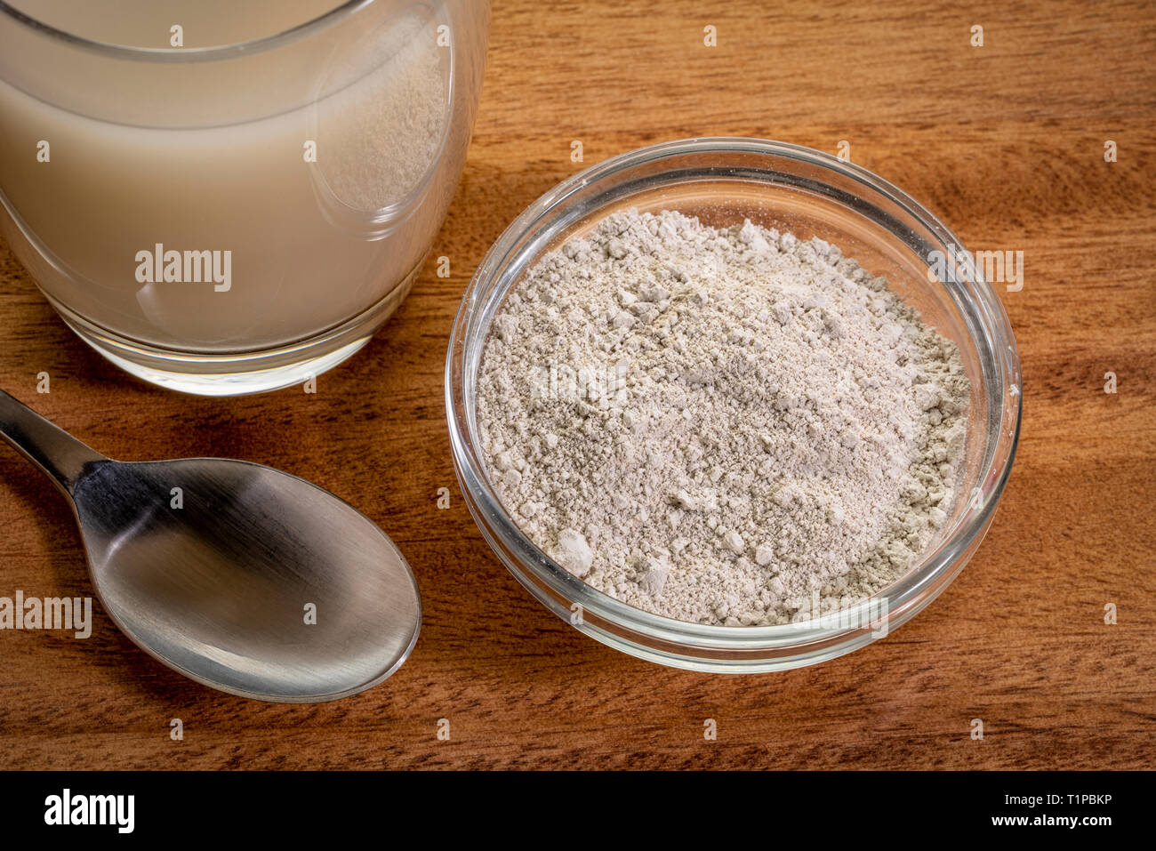 food grade diatomaceous earth supplement - powder and in a glass of water Stock Photo - Alamy