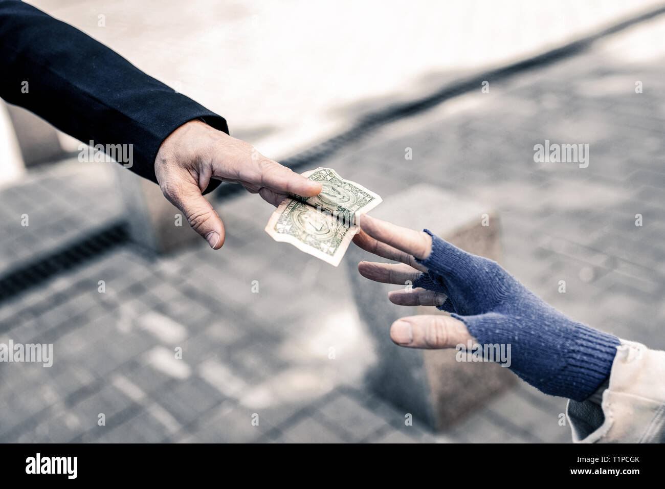 Caring man putting money in hands of needed old man Stock Photo - Alamy