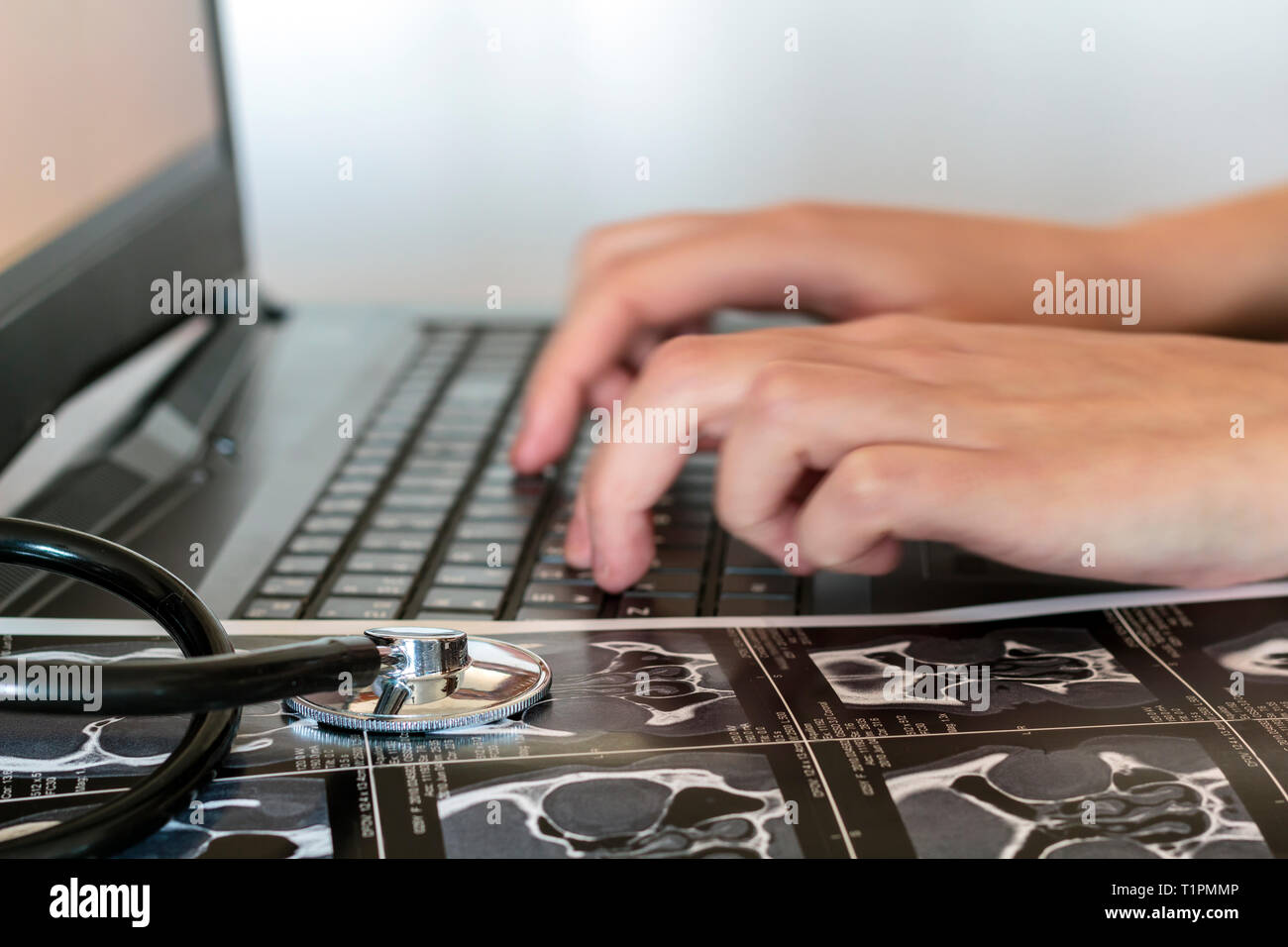 Doctor writes medical report on the computer Stock Photo - Alamy