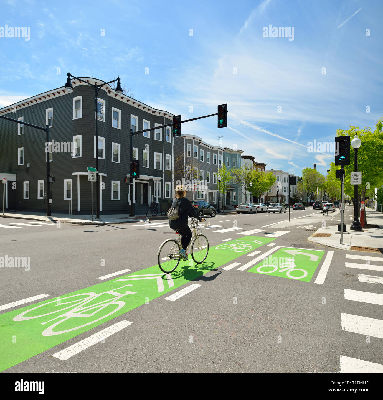 Clear street signs and markings on protected bike lane Stock Photo