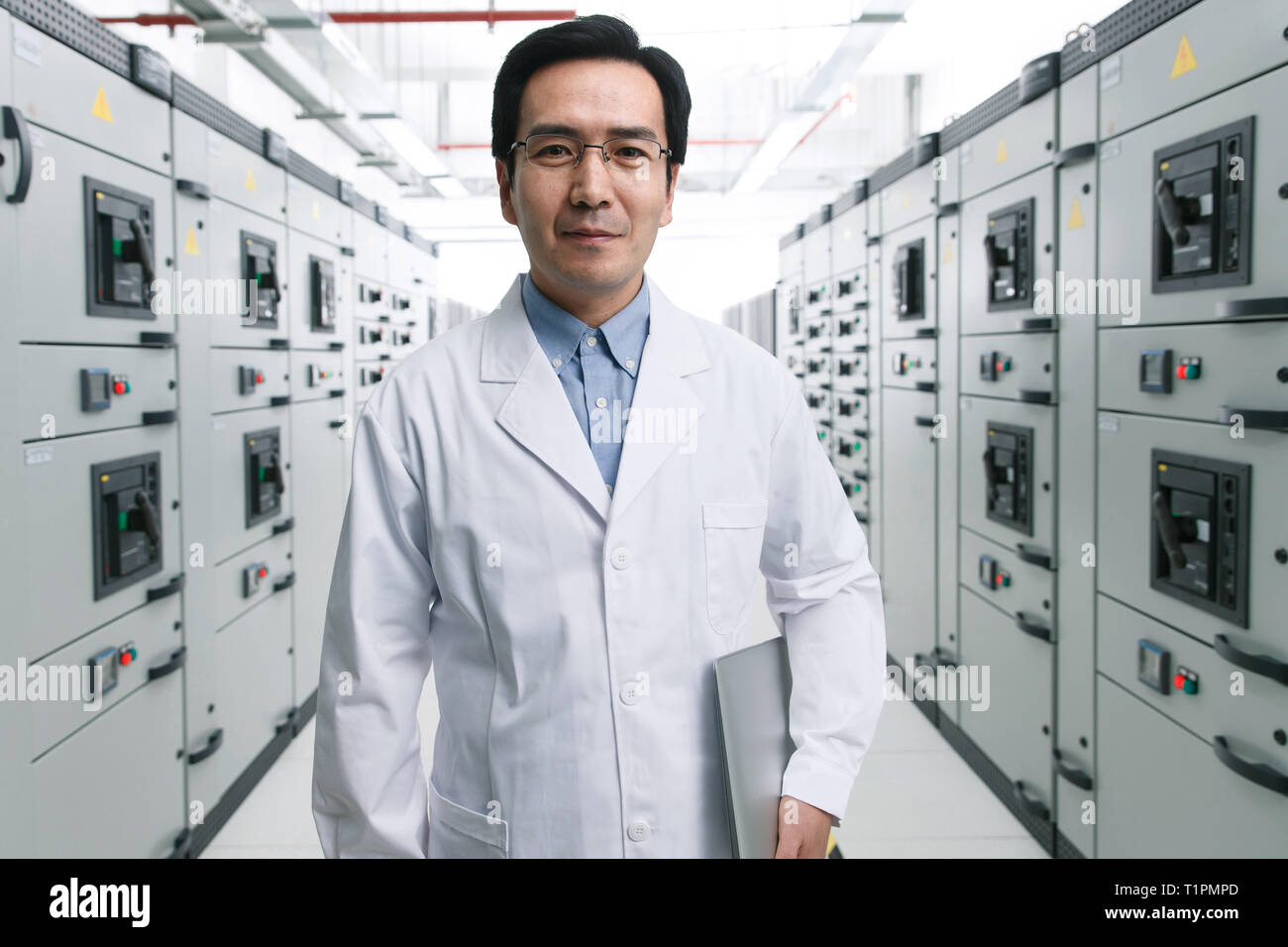 Technical personnel in the voltage room work Stock Photo