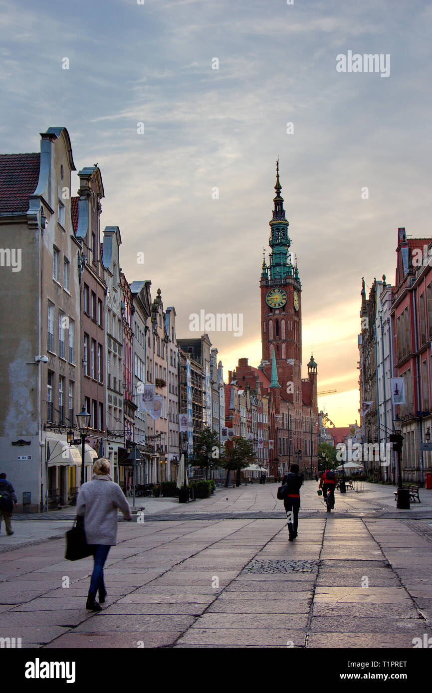 sunrise on Dluga street, view on renewed houses and city hall Stock Photo