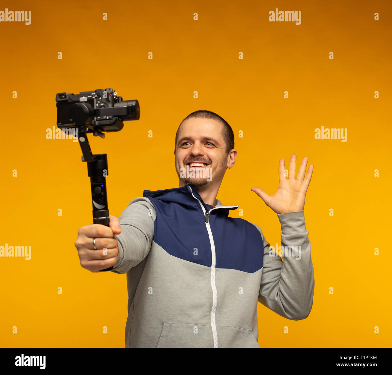 Man vlogger or blogger or videographer filming hisself on camera Stock Photo