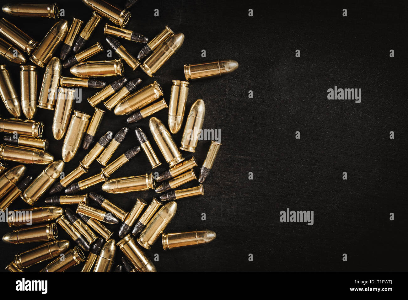 bullets from the gun placed on a black wooden table Stock Photo - Alamy