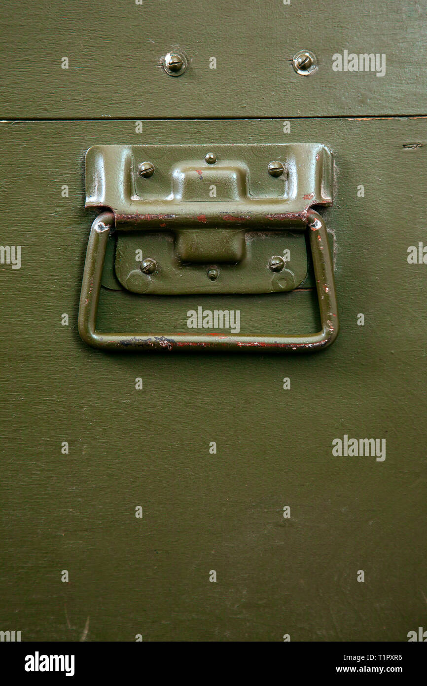 A green military storage box for ammunition. Green box from the war with scratches and locks in