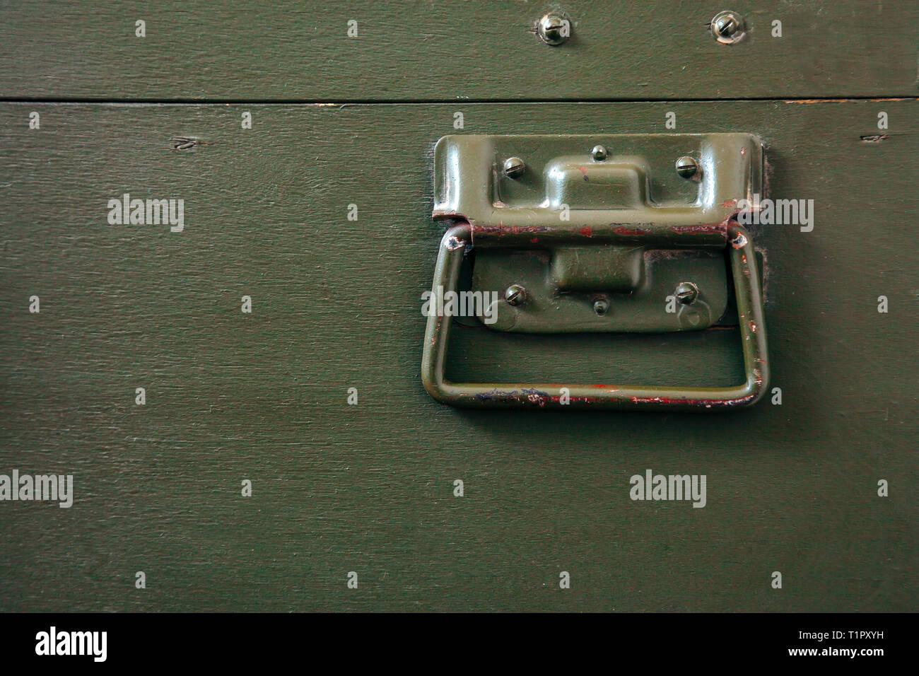 A green military storage box for ammunition. Green box from the war with scratches and locks in