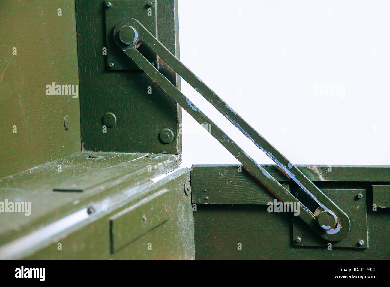 A green military storage box for ammunition. Green box from the war with scratches and locks in