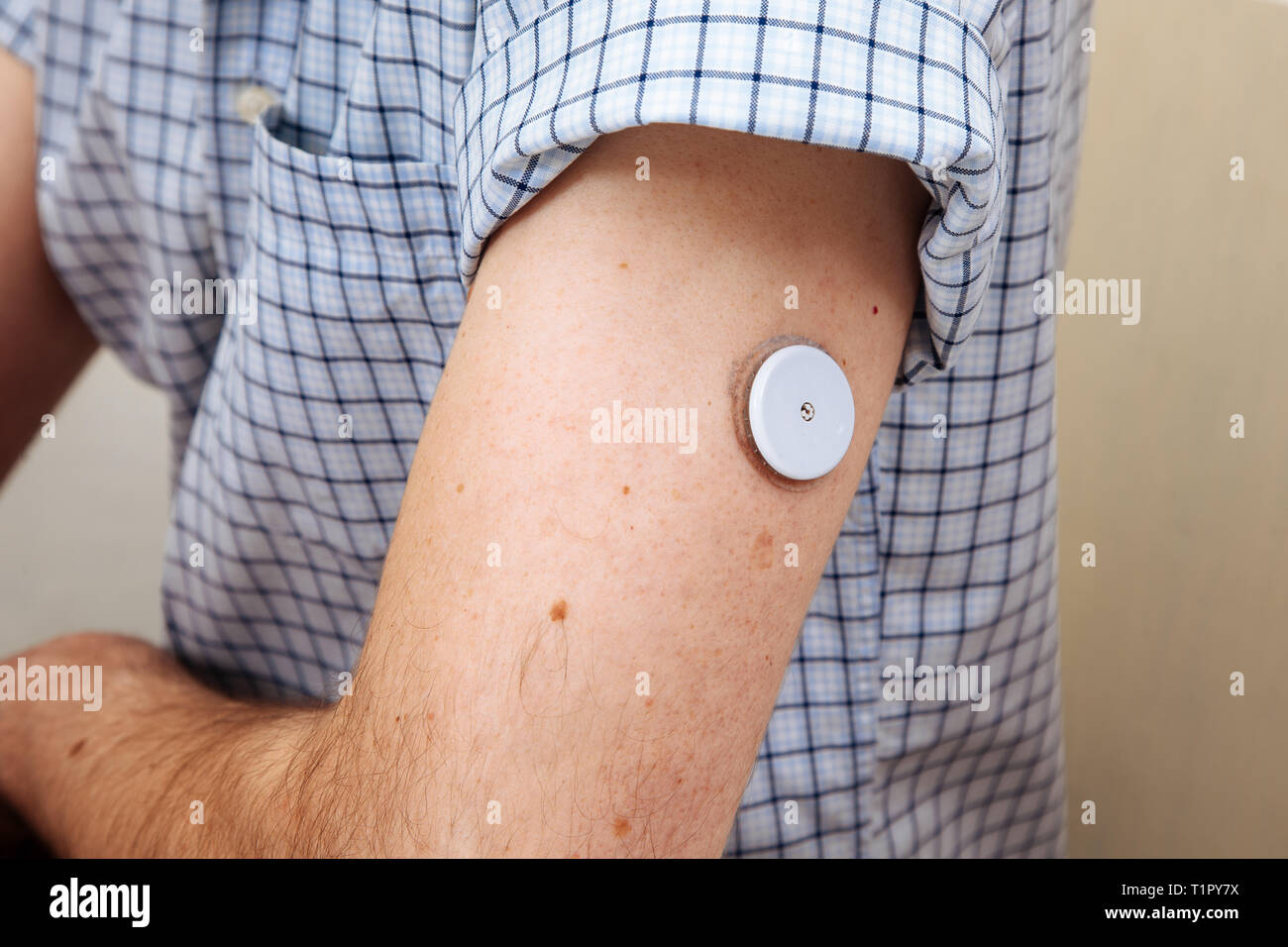 Man testing glucose level with a digital sensor checkup