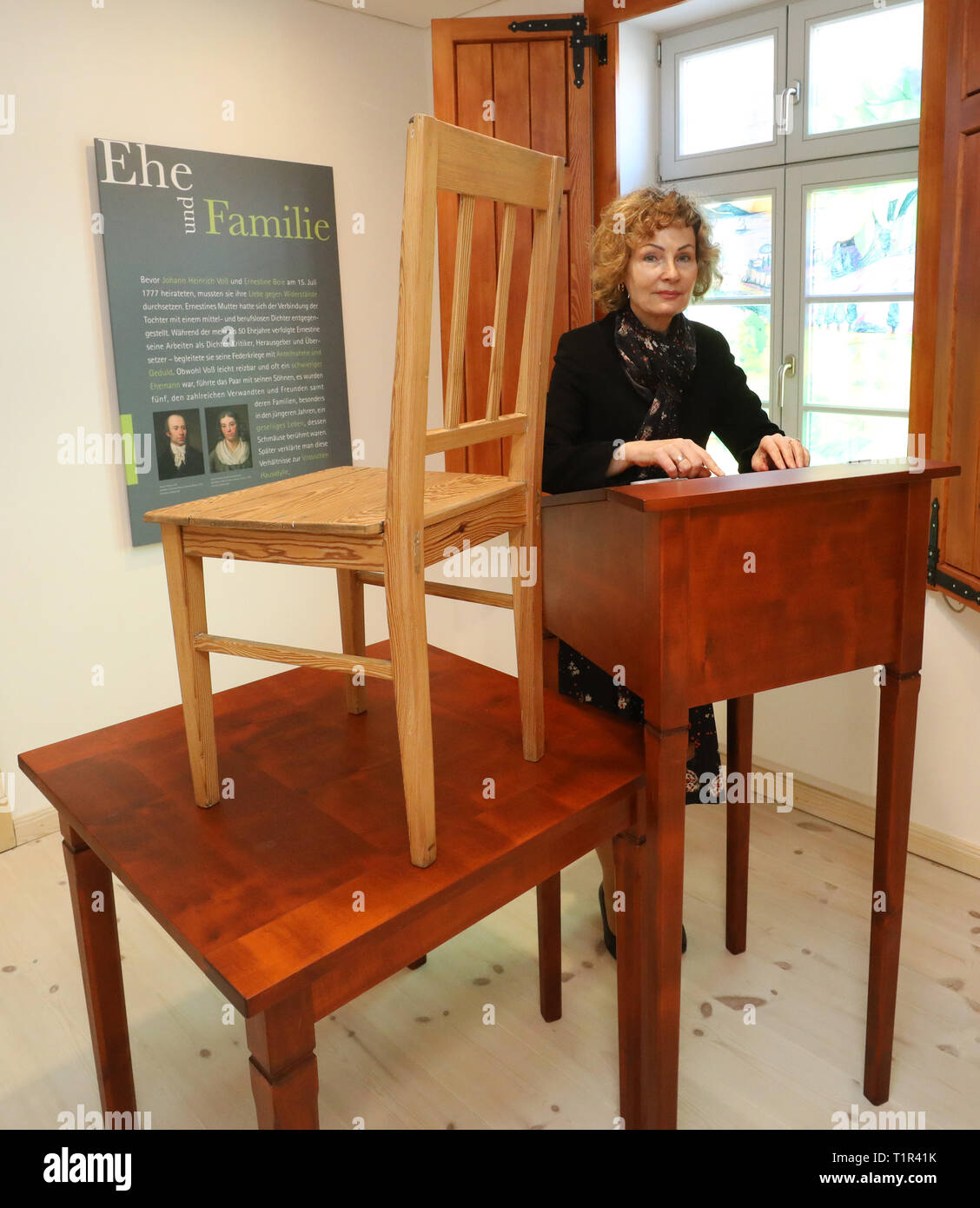 25 March 2019, Mecklenburg-Western Pomerania, Penzlin: Andrea Rudolph, director, stands in the exhibition 'Johann Heinrich Voß. A Greek from Mecklenburg' in the future Literaturhaus at Voss' standing desk. Voss's wife was sitting on a chair on a table next to him at the time, so that could be done together with a candle. The rebuilt and extended town school, in which Johann Heinrich Voss (1751-1826) learned from 1759-1766, is opened on 29.03.2019 as a literary house for the Homer translator. The most famous son of the city became known as a poet especially with translations of the 'Odyssey' an Stock Photo