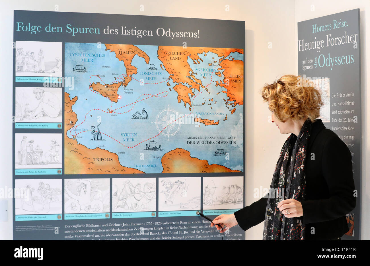 25 March 2019, Mecklenburg-Western Pomerania, Penzlin: In the exhibition 'Johann Heinrich Voß. A Greek from Mecklenburg' in the future Literaturhaus shows Andrea Rudolph, director, a map of the Mediterranean region where the individual legends of Odysseus played. The rebuilt and extended town school, in which Johann Heinrich Voss (1751-1826) learned from 1759-1766, is opened on 29.03.2019 as a literary house for the Homer translator. The most famous son of the city became known as a poet especially with translations of the 'Odyssey' and the 'Iliad', to which also the legend about the conquest Stock Photo