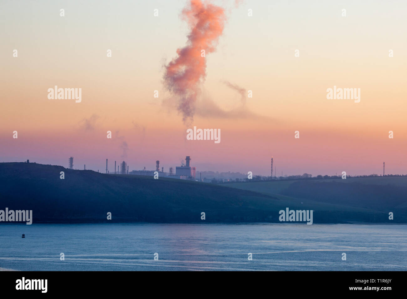 Whitegate, Cork, Ireland. 28th March, 2019. First light begins to illuminate the oil refinery in Cork harbour at Whitegate, Co. Cork, Ireland. Credit: David Creedon/Alamy Live News Stock Photo